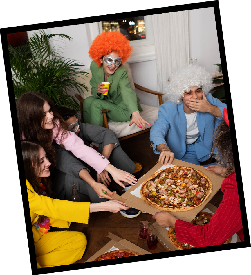 Friends in colorful party outfits sharing pizza